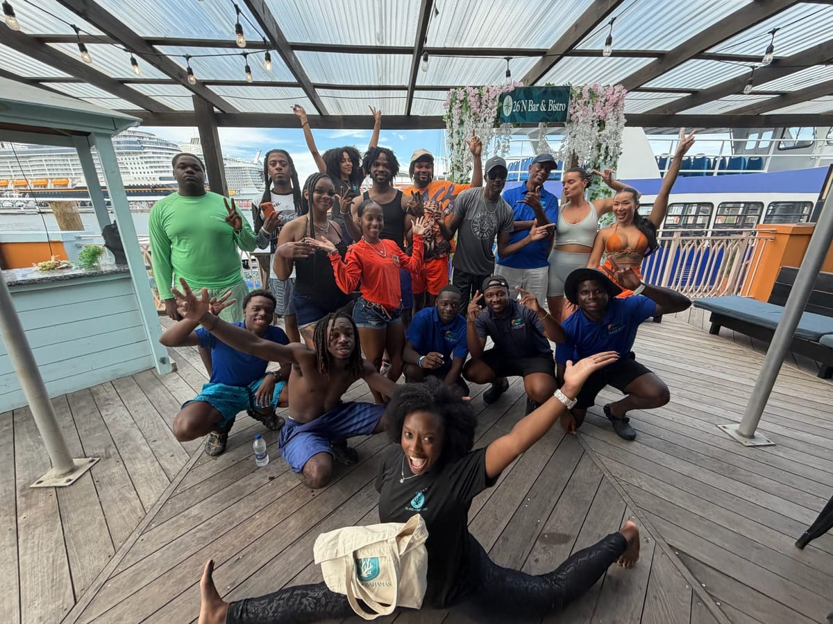 Pilates Brunch guests cheering with arms in the air on the terrace