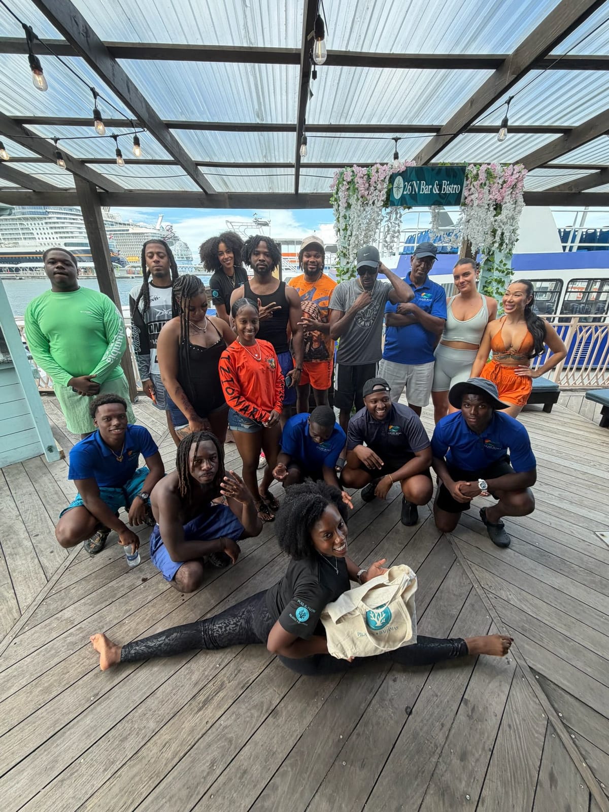 The Pilates Brunch group posing together on the terrace, one guest in a split at the front