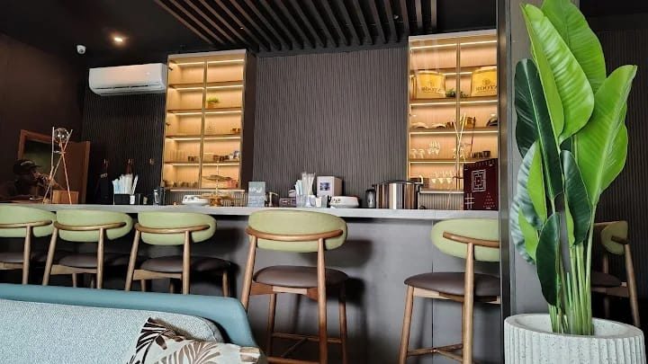 The ROOTZ bar: lit shelves and green bar stools